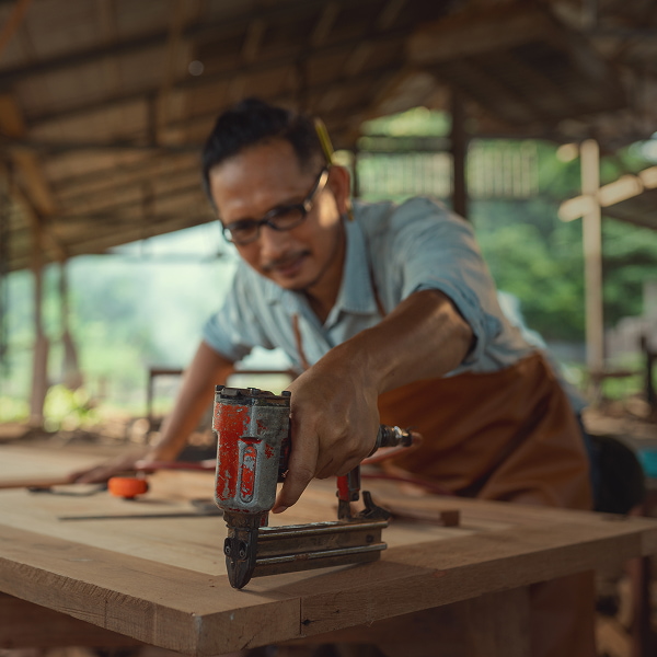 Carpenter Uses A Nail Gun To Assemble Wood Furnitu Carpenter Uses A Nail Gun To Assemble Wood Furnitu
