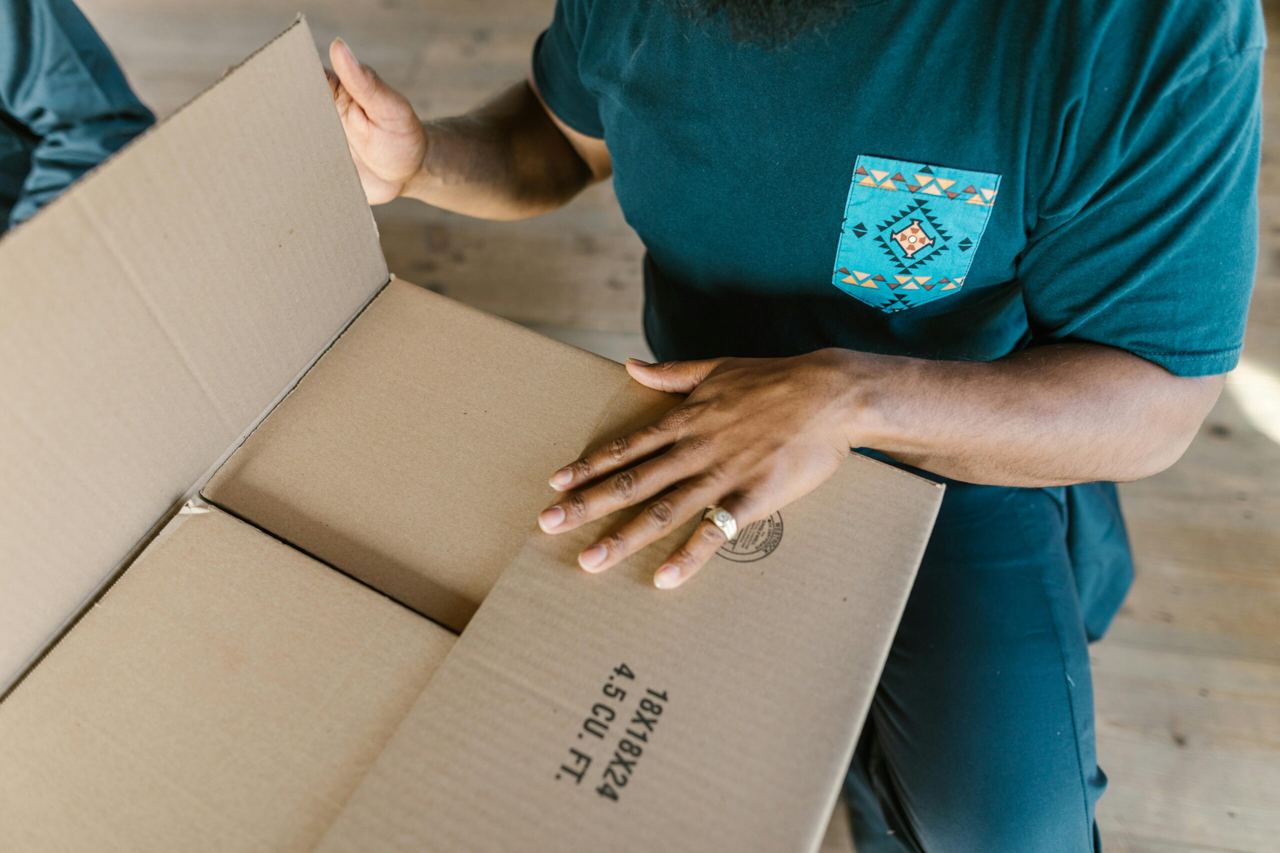 Packing belongings into a box for domestic shipping within Thailand