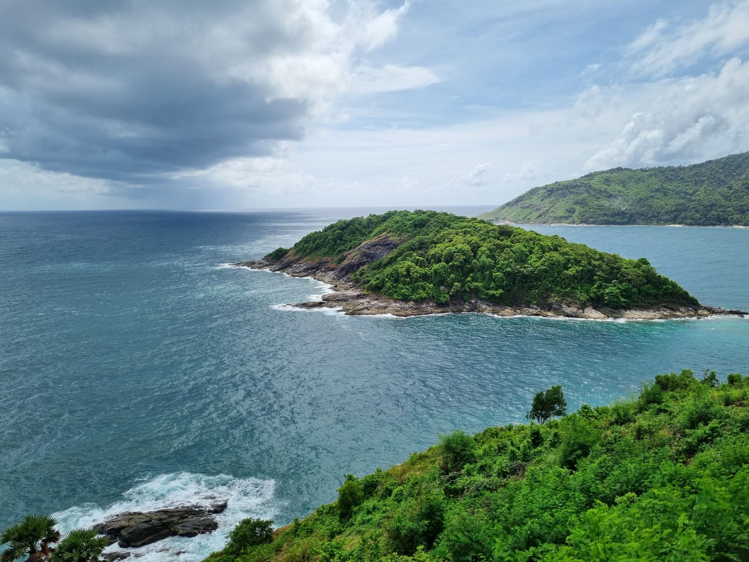 A secluded tropical beach surrounded by jungle and cliffs representing one of Phuket's hidden beaches.